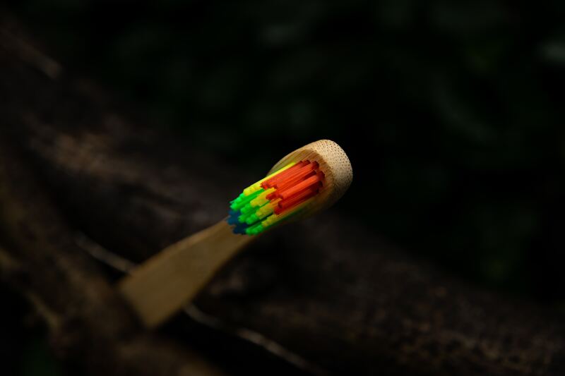 a toothbrush with rainbow-colored bristles