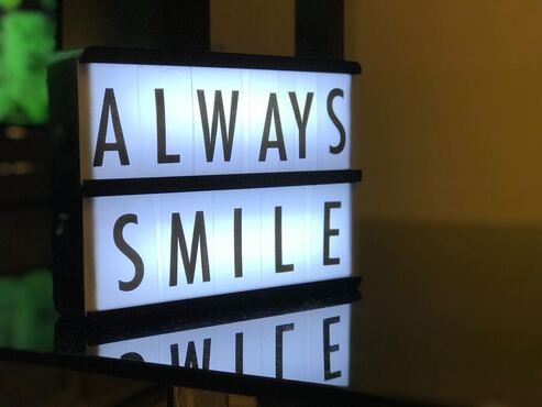 a sign that says always smile - reminder to have healthy teeth